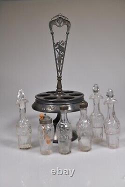 C. 3Q 1800s GOTHIC by Union Glass CLEAR withHall, Elton FRAME 6 Bottle Caster Set
