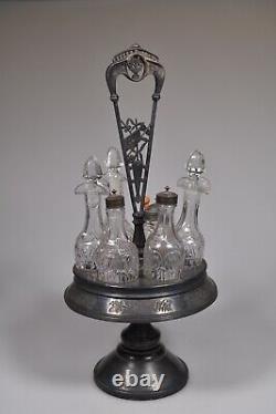 C. 3Q 1800s GOTHIC by Union Glass CLEAR withHall, Elton FRAME 6 Bottle Caster Set